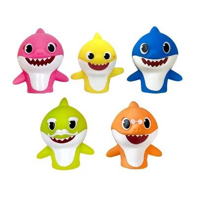 four different types of toy sharks with big eyes and teeth on each one's face