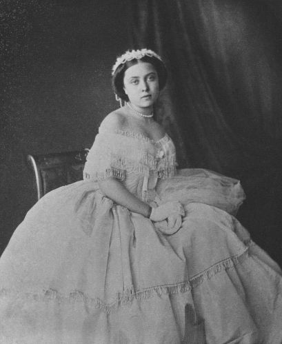 an old black and white photo of a woman in a dress