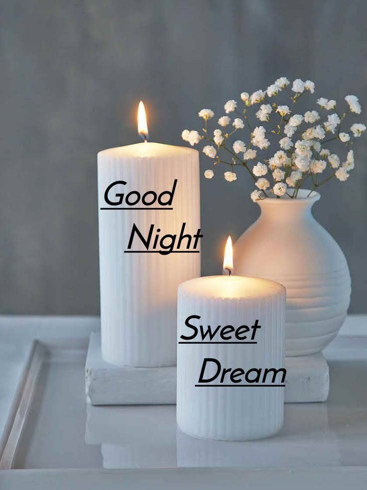 two white candles sitting next to each other with the words good night and sweet dream written on them