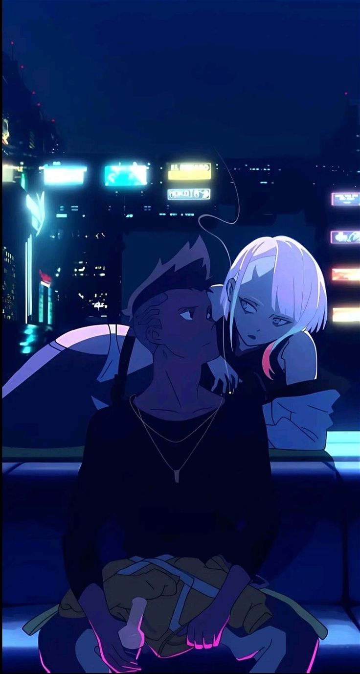 two people sitting on a bench in front of a city at night with neon lights