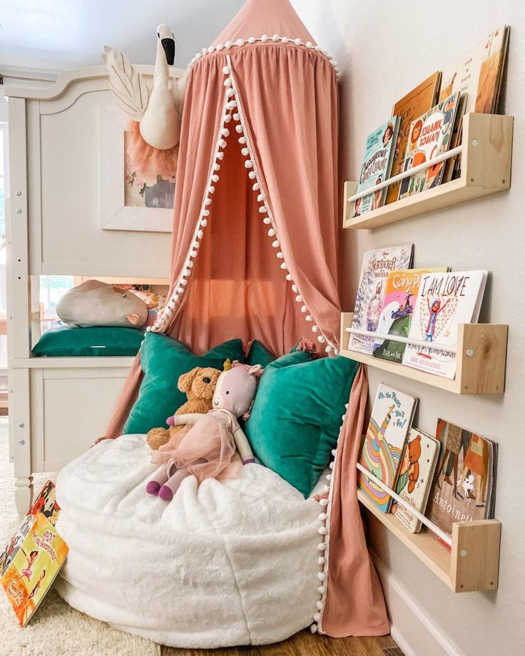 a bedroom with a canopy bed and bookshelves on the wall next to it