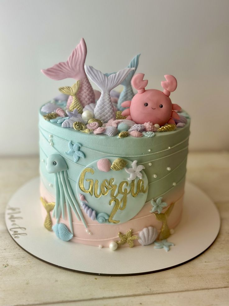 a birthday cake decorated with sea animals and shells