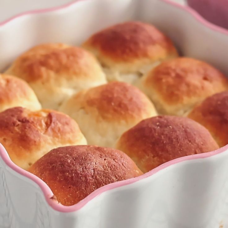 rolls in a white baking dish with pink trim