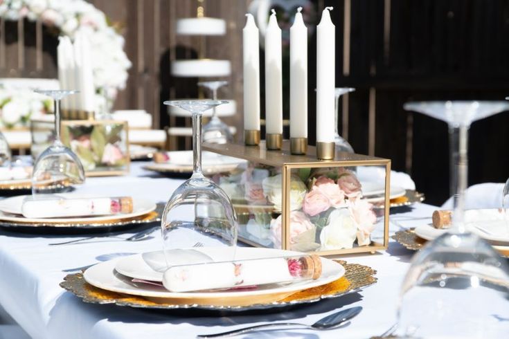 the table is set with candles and plates