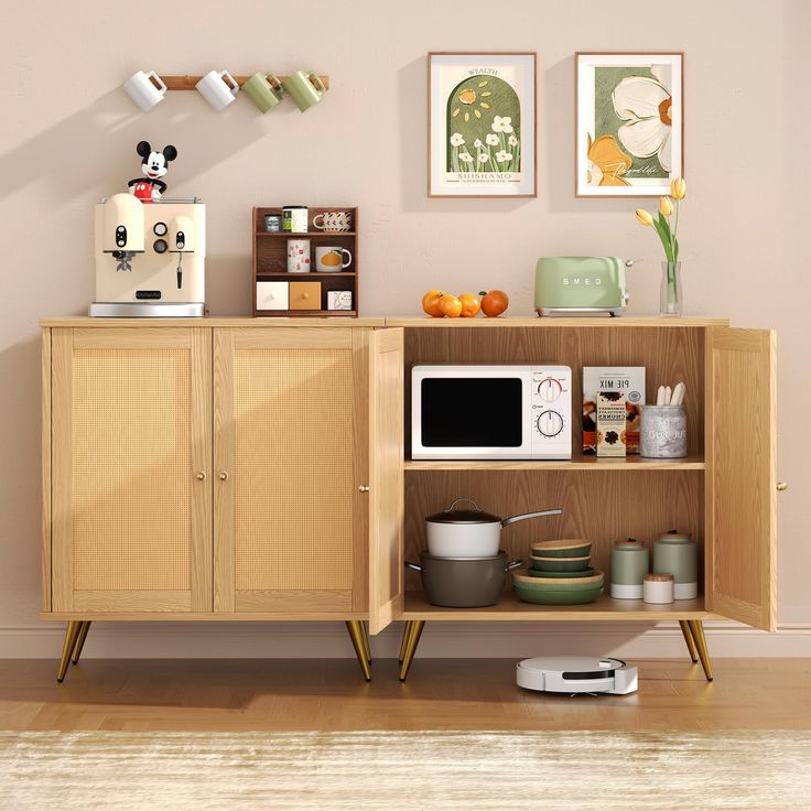 a microwave oven sitting on top of a wooden cabinet next to a shelf filled with pots and pans