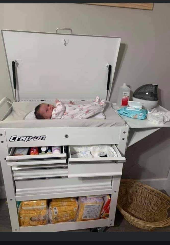 a baby is laying in an inclosure on the floor