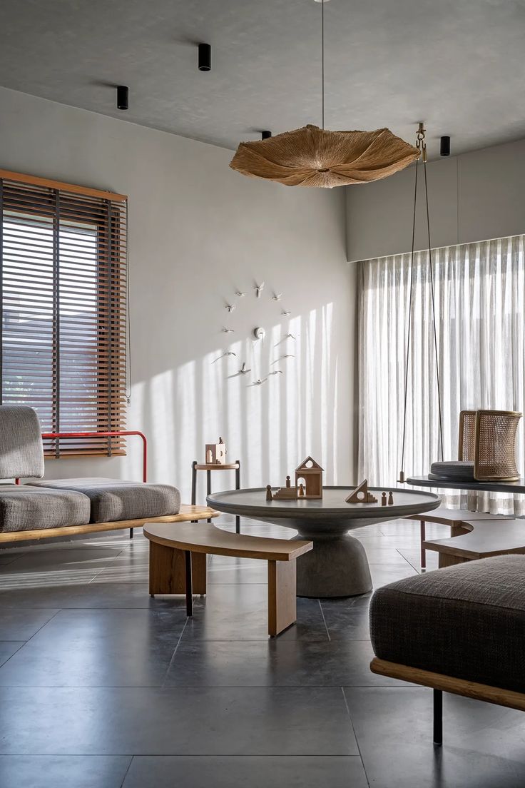 a living room filled with furniture and windows