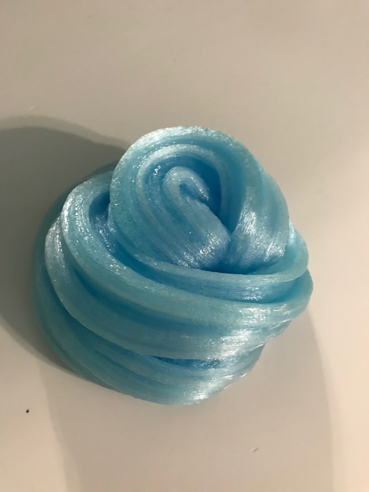 a blue ball of yarn sitting on top of a white table