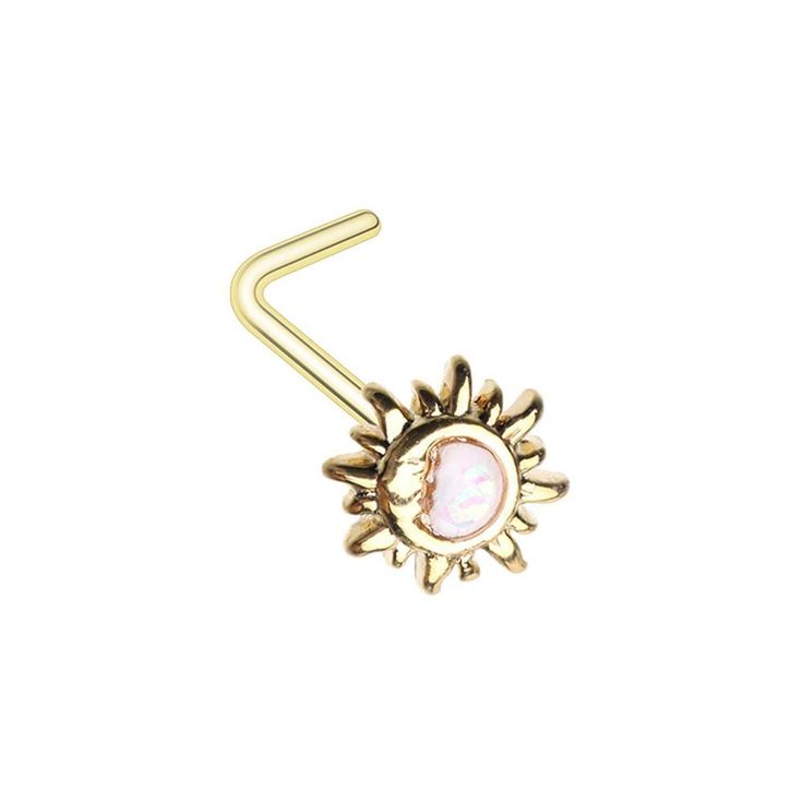 a gold nose ring with a pink stone in the center and sunburst on it