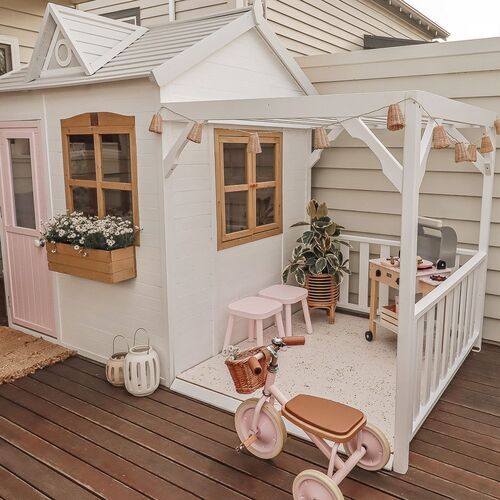 a small doll house on a wooden deck