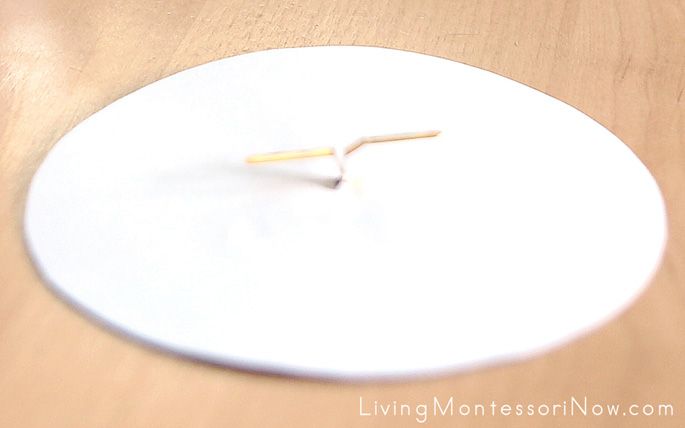 a white clock sitting on top of a wooden table