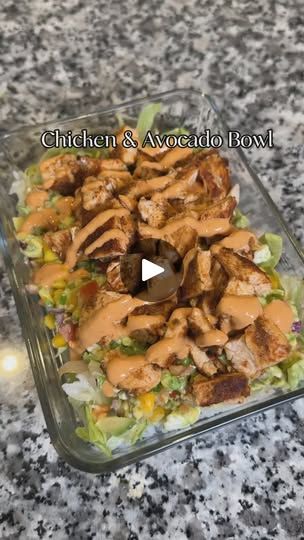 chicken and avocado bowl in a glass dish on a granite countertop with the words, kitchen & avocado bowl