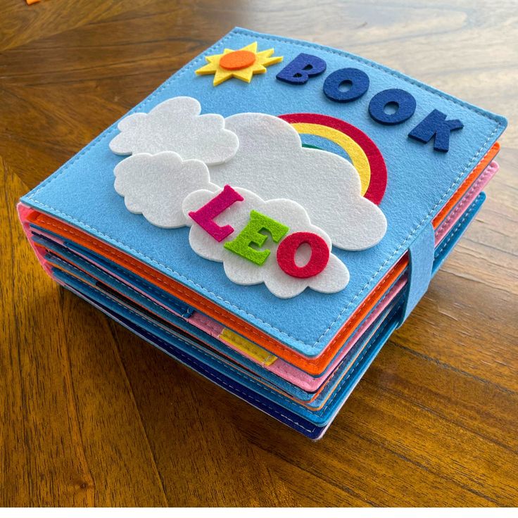 a stack of children's books sitting on top of a wooden table