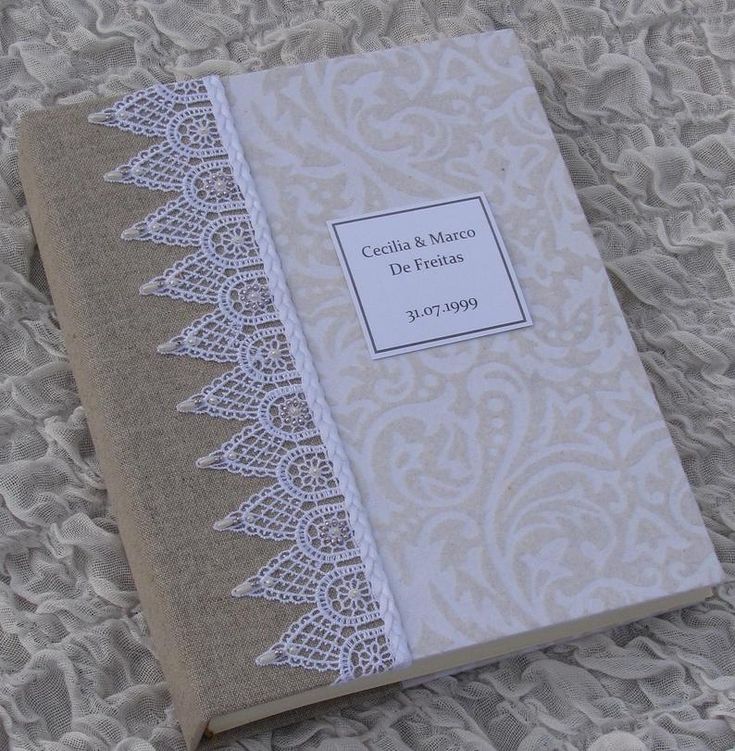 a book with lace on it sitting on a bed