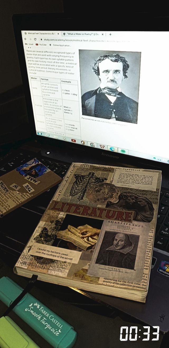 an open laptop computer sitting on top of a desk covered in old newspapers and papers