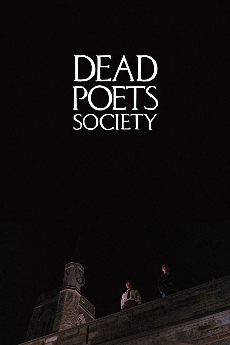 two people standing on top of a building at night with the words dead poets society above them