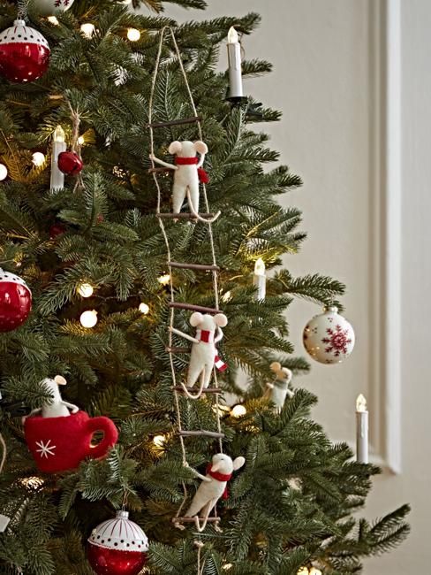 a christmas tree with ornaments and candles on it