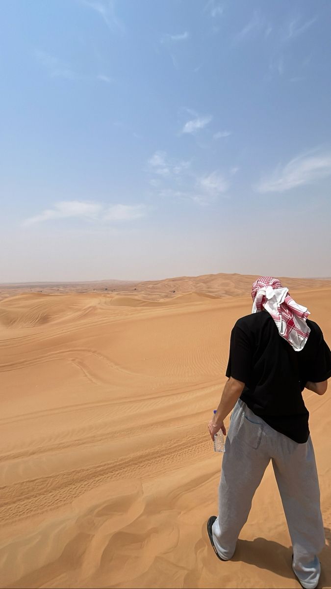 a man standing in the middle of a desert