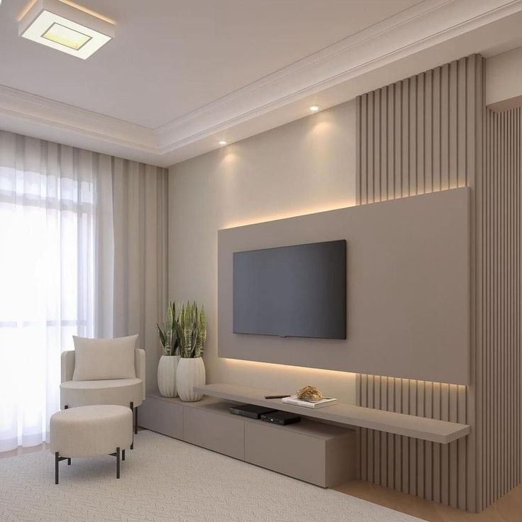 an empty living room with a flat screen tv on the wall and two white chairs