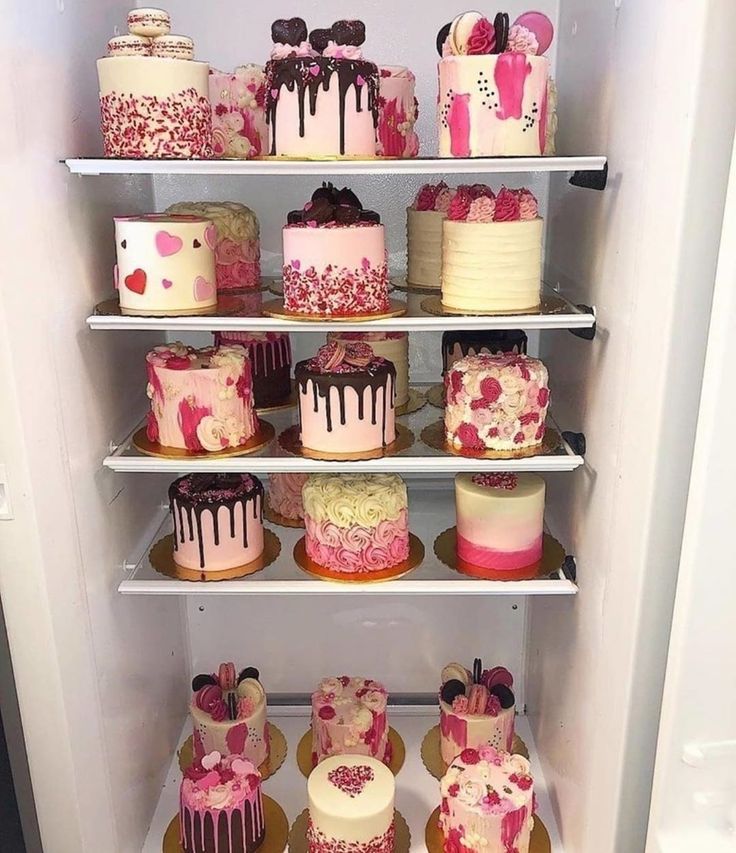 a refrigerator filled with lots of different types of cakes