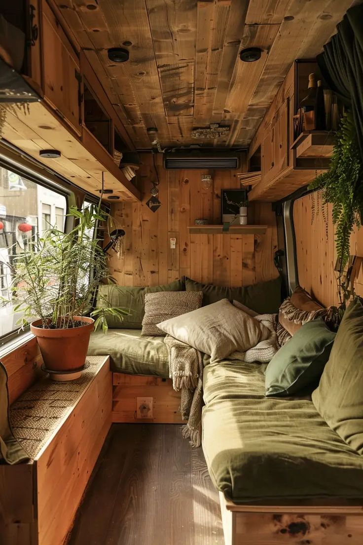 the interior of an rv with wood paneling and plants on the windowsills