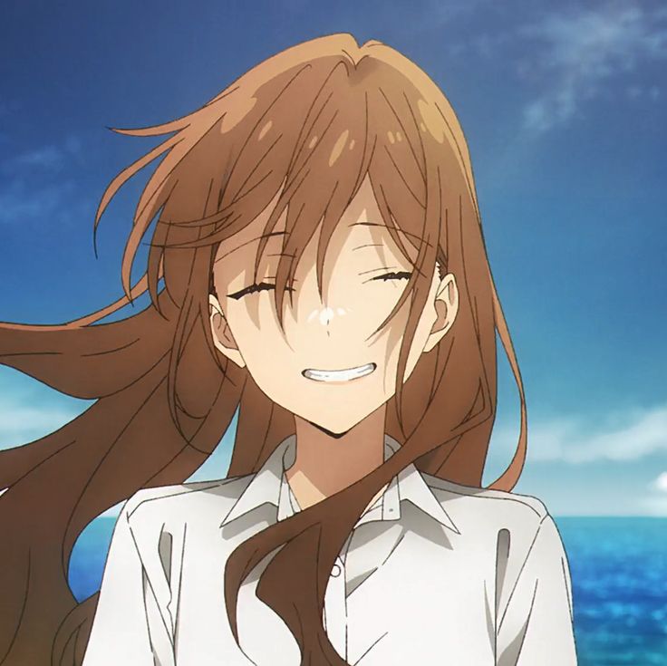 an anime character with long hair standing in front of the ocean