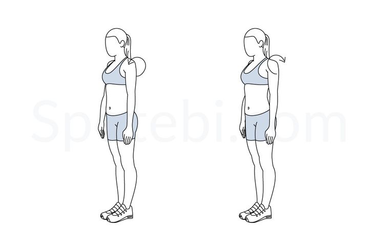 a woman standing in front and back view with her hand on her hip, looking at the