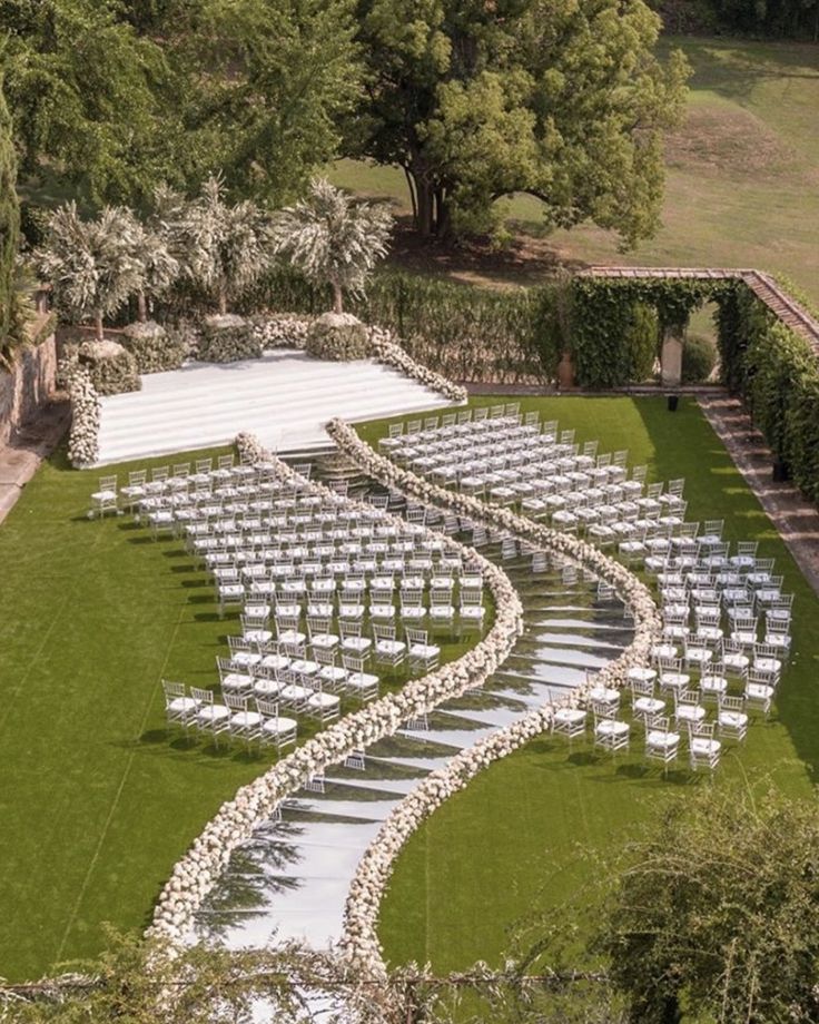 an aerial view of a wedding venue with rows of chairs set up for the ceremony