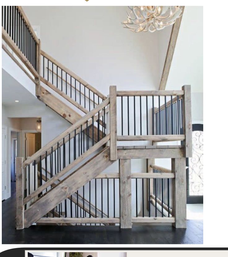 an open staircase in a house with wood flooring and chandelier hanging from the ceiling