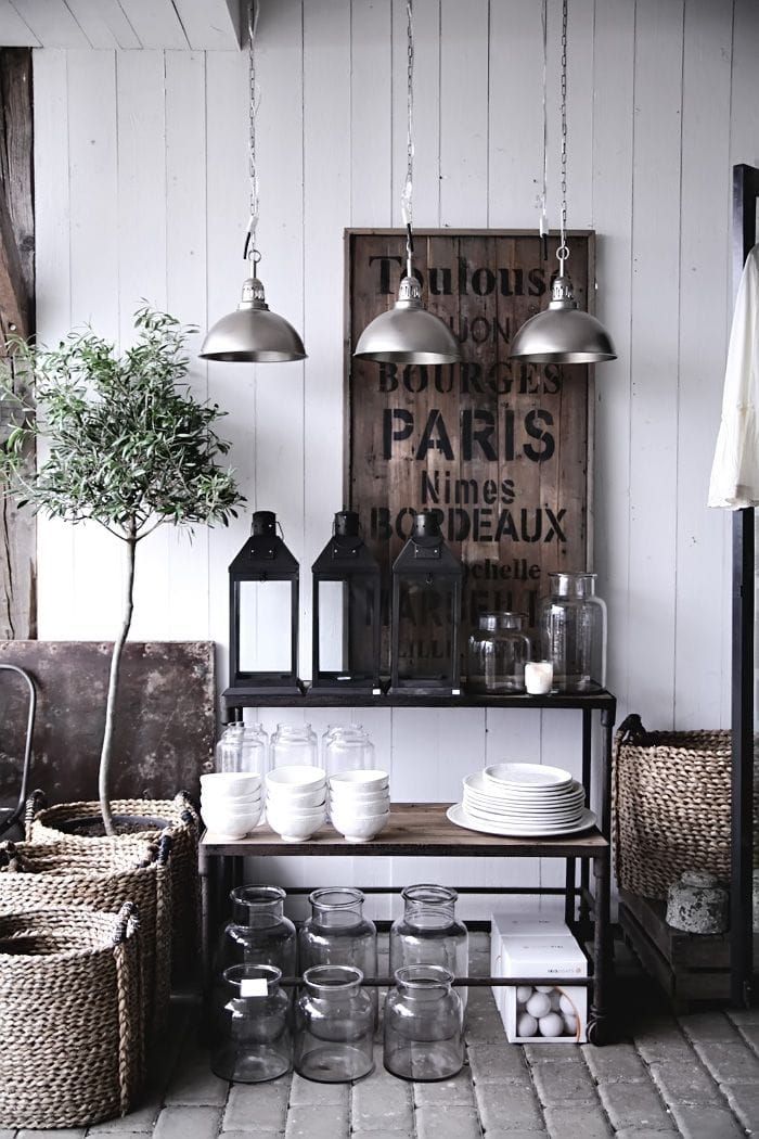 a room filled with lots of glass jars and baskets on top of a wooden table