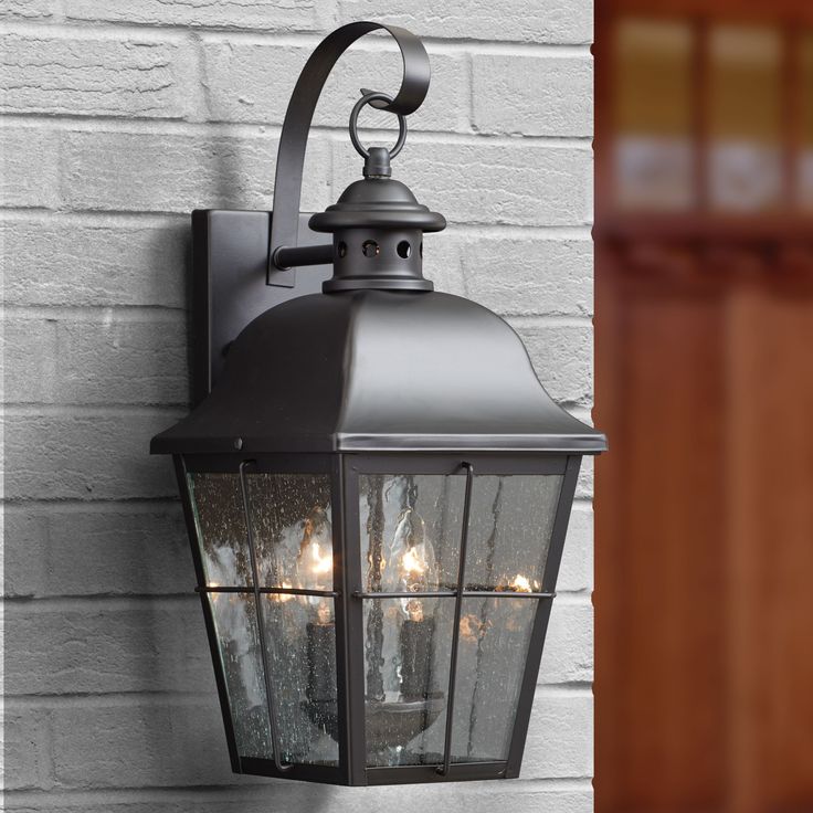 With simple details and traditional style the Millhouse outdoor collection is perfect for understated elegant lighting. The design features clear seedy glass that diffuses the light in a soft tranquil way and the rich Mystic Black finish completes the look. Quoizel Millhouse 1-Light 15-in H Black Outdoor Wall Light | MHE8406K Door Lighting, Black Candelabra, Front Door Lighting, Garage Lights, Outside Lights, Outdoor Wall Mounted Lighting, Driveway Ideas, Coach Lights, Exterior Light Fixtures