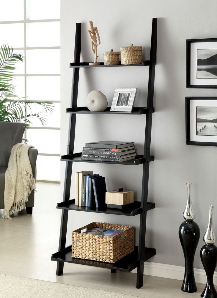 a black leaning shelf with books on it