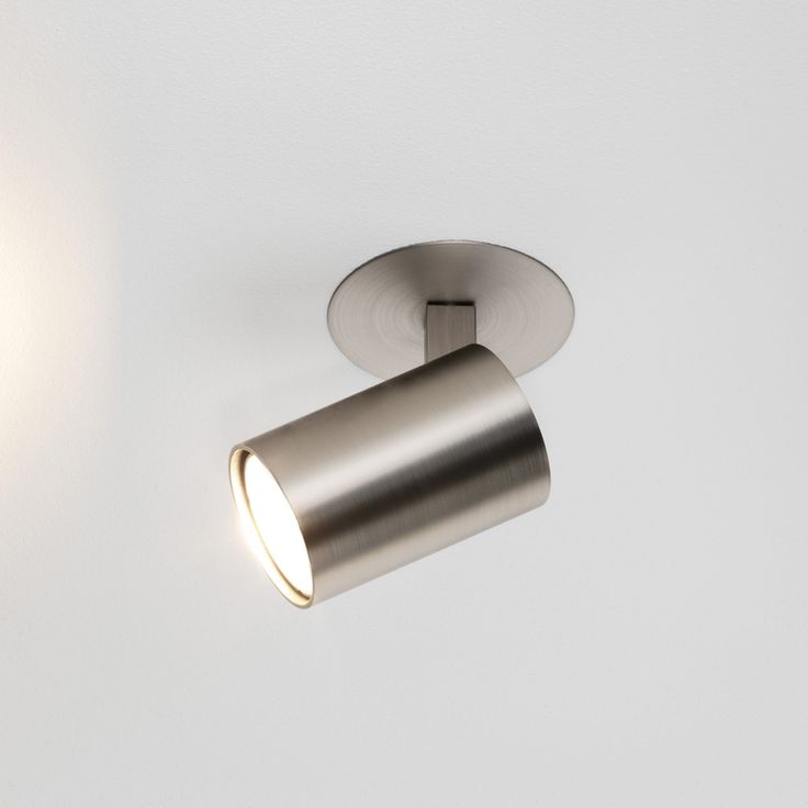 a close up of a light on a wall with a white ceiling and walls in the background