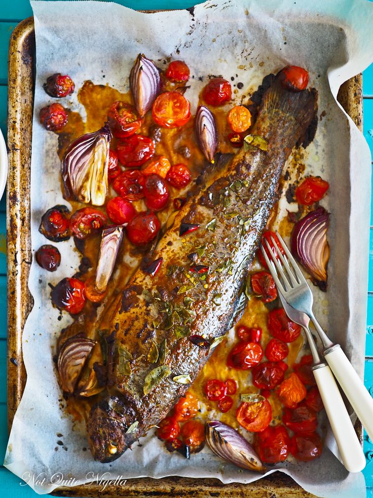 fish with tomatoes and onions on a tray