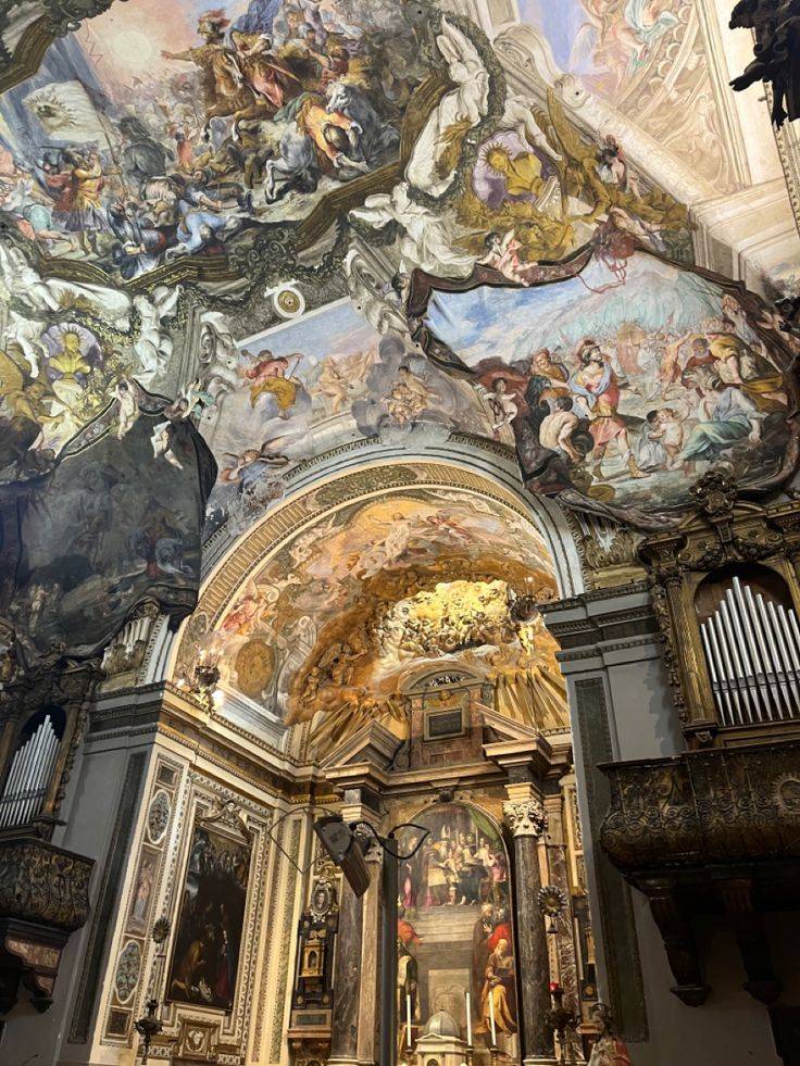 the interior of a church with paintings on the ceiling