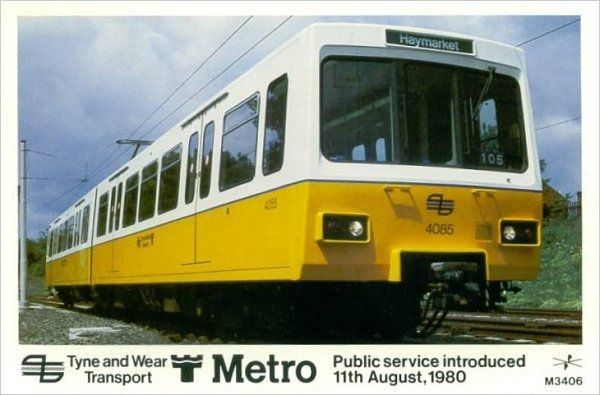 a yellow and white metro train on the tracks with an advertisement for it's service