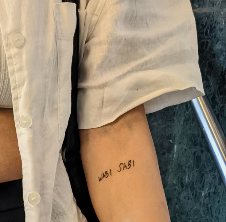 a person with a tattoo on their arm that reads, who said i love you?