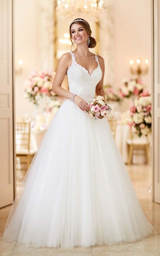 a woman in a white wedding dress posing for the camera