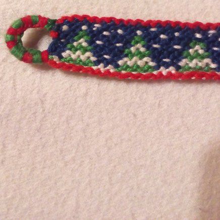 a crocheted keychain with a red, white and blue handle on it