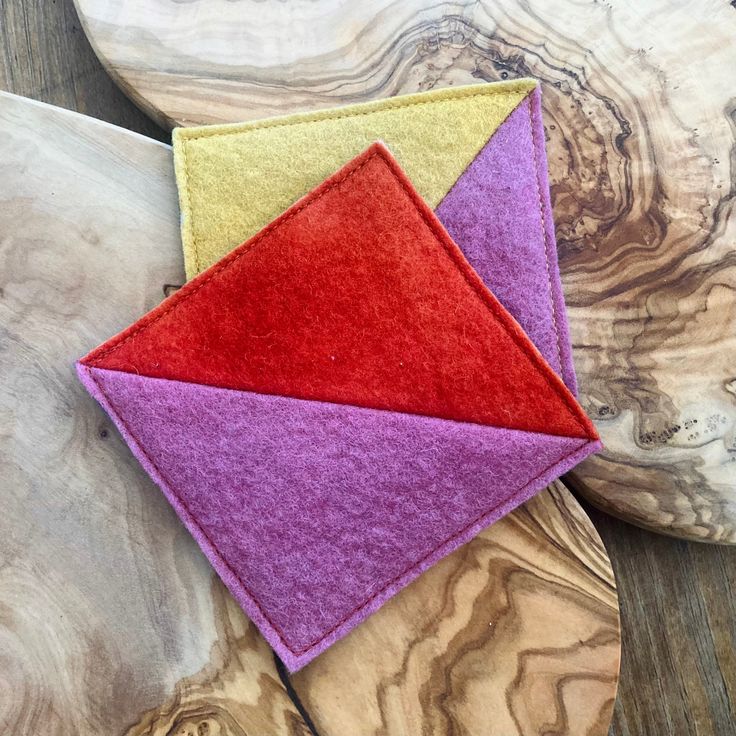 two pieces of felt sitting on top of a wooden table