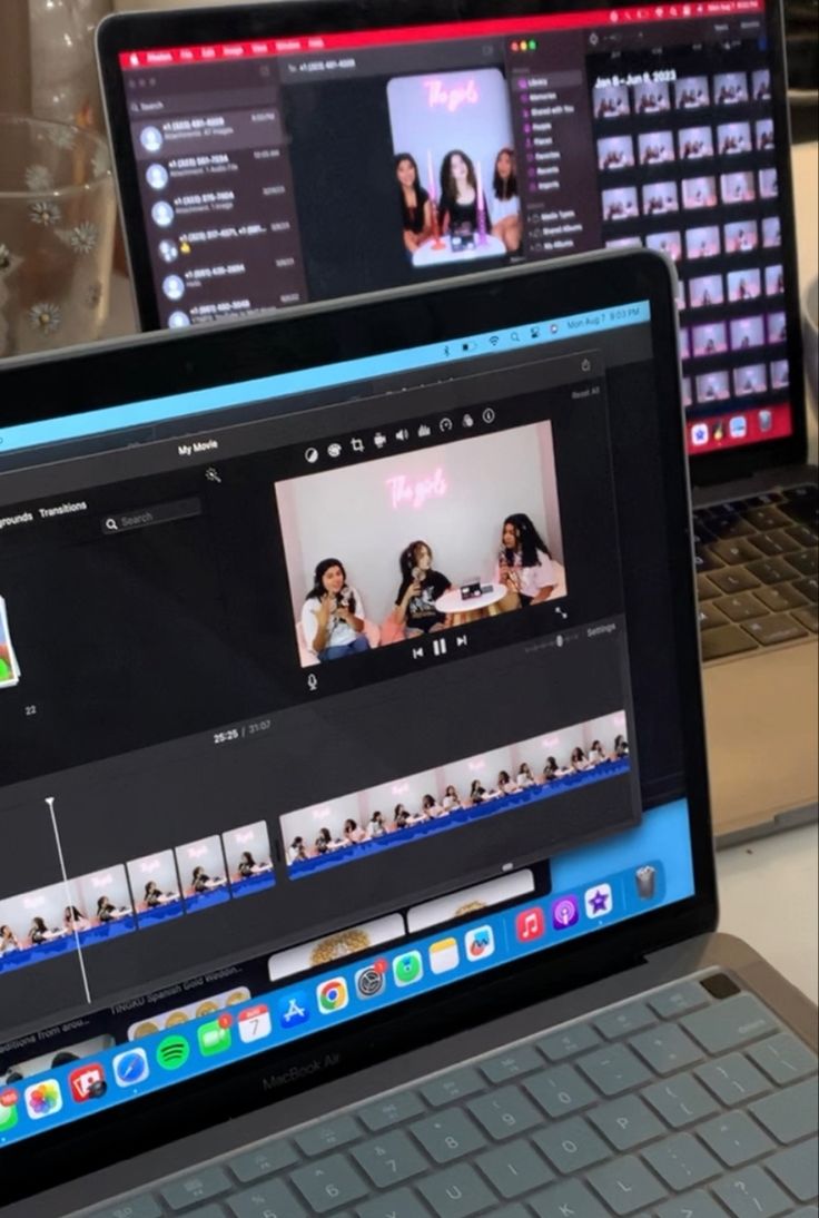 two laptops sitting next to each other on a table