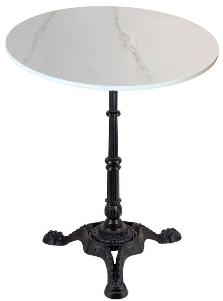 a white marble top table with black metal legs and an ornate design on the base