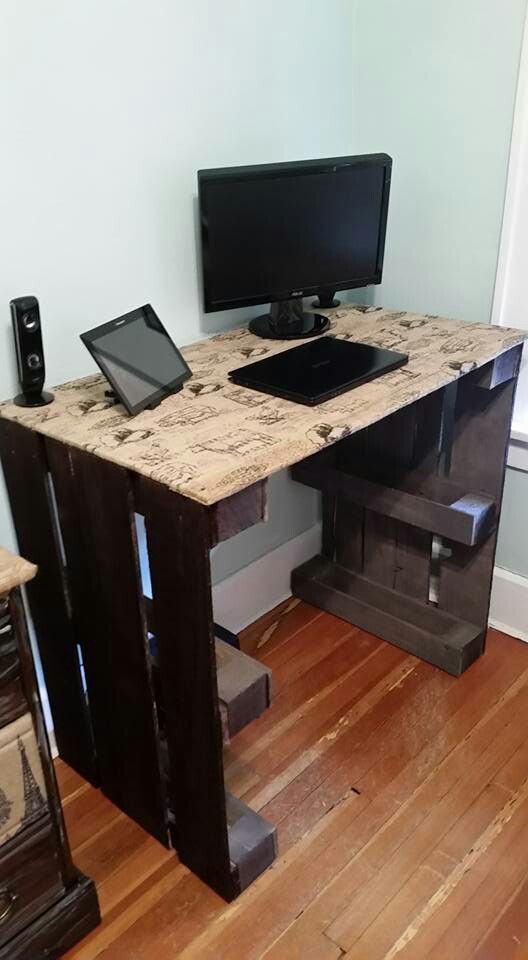 a computer desk with a tablet on top of it next to a monitor and speakers