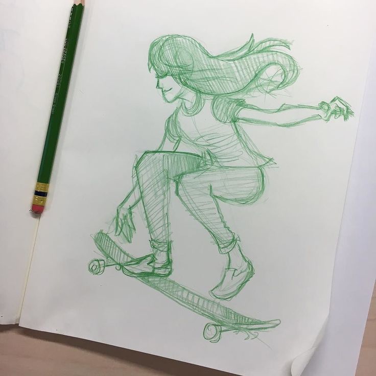 a drawing of a girl riding a skateboard on paper with a green marker next to it