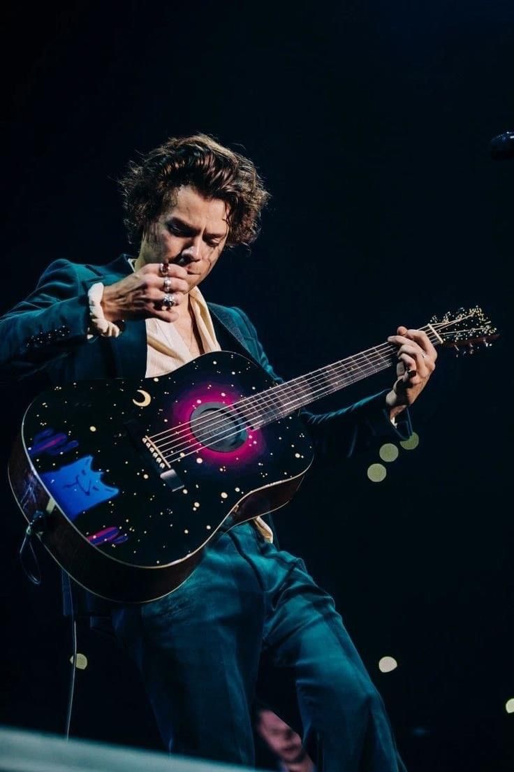 a man playing an electric guitar on stage