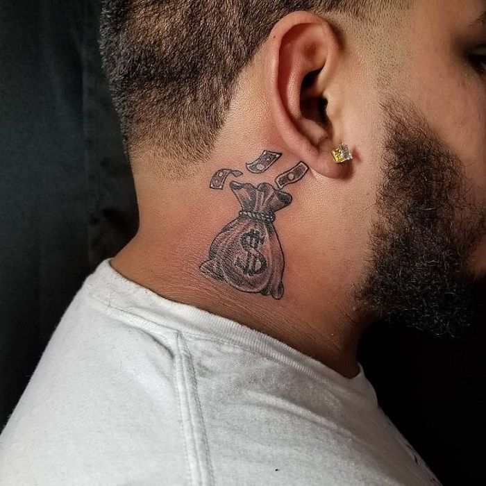 a man with a tattoo on his neck has a bag of money in the shape of a cross