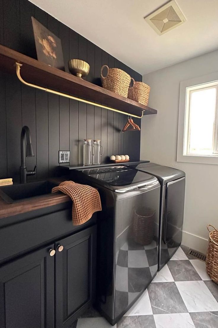 a black and white checkered floor in a kitchen with shelves above the washer and dryer