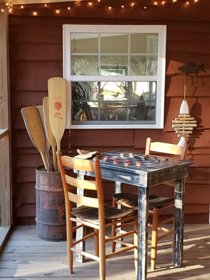 a wooden table and chairs on a porch