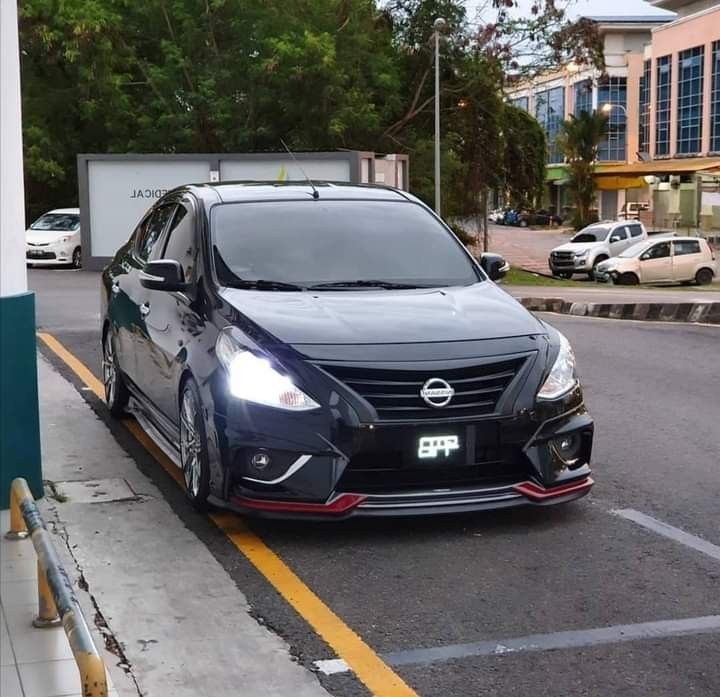 a black car is parked on the side of the road