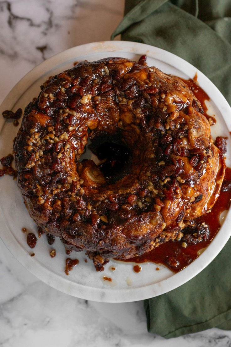 a bundt cake on a plate covered in sauce